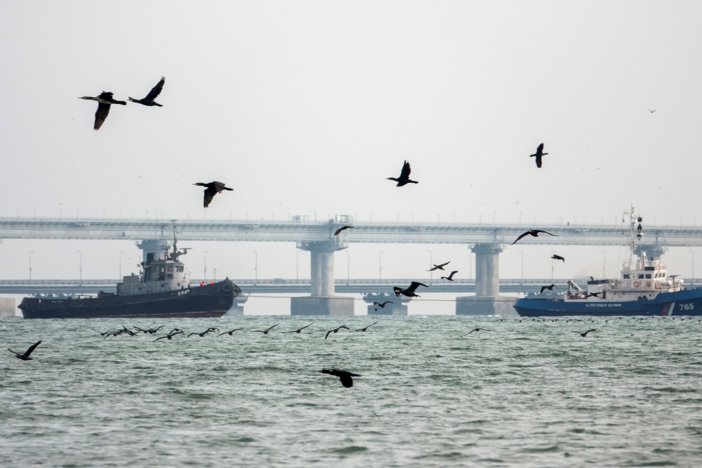 A seized Ukrainian ship is towed by a Russian Coast Guard vessel out of the port in Kerch. Photo: Reuters