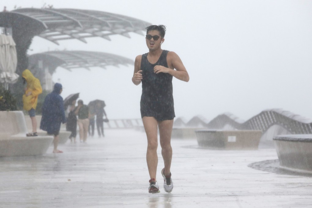 A runner in the rain may be happy, but a good windproof or waterproof jacket can make all the difference. Photo: May Tse