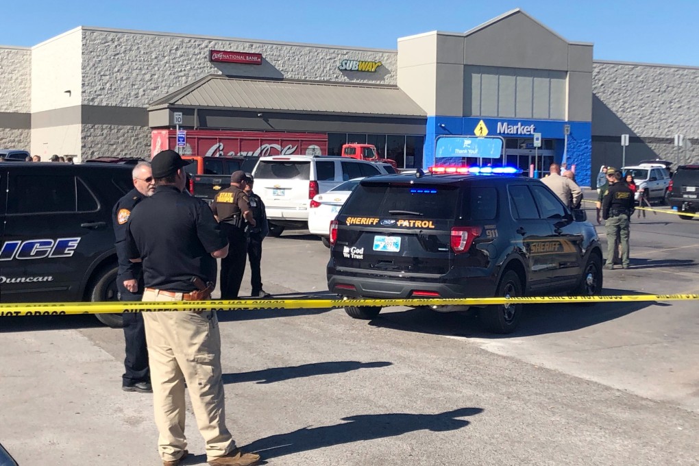 Law enforcement personnel at the scene of the fatal shooting of two men and a woman on Monday outside a Walmart store in Duncan, Oklahoma. Photo: AP