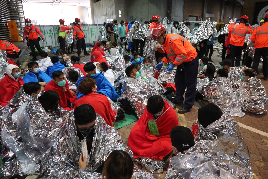 Protesters wait for medics to arrive at Hong Kong Polytechnic University in Hung Hom district on Tuesday morning. Photo: Felix Wong