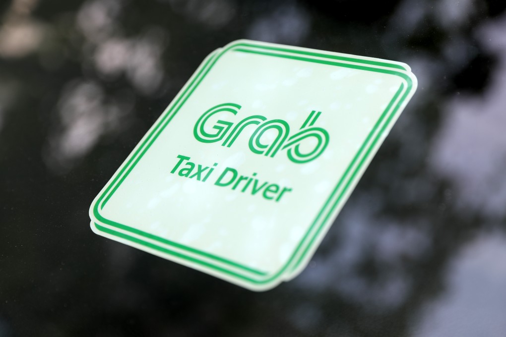 The Grab logo is displayed on the windshield of a GrabTaxi. Photo: Bloomberg