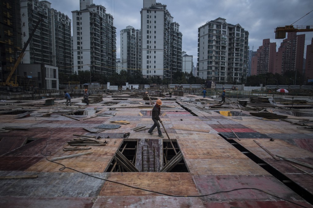 A man works at a construction site of a residential skyscraper in Shanghai. Photo: Agence France-Presse