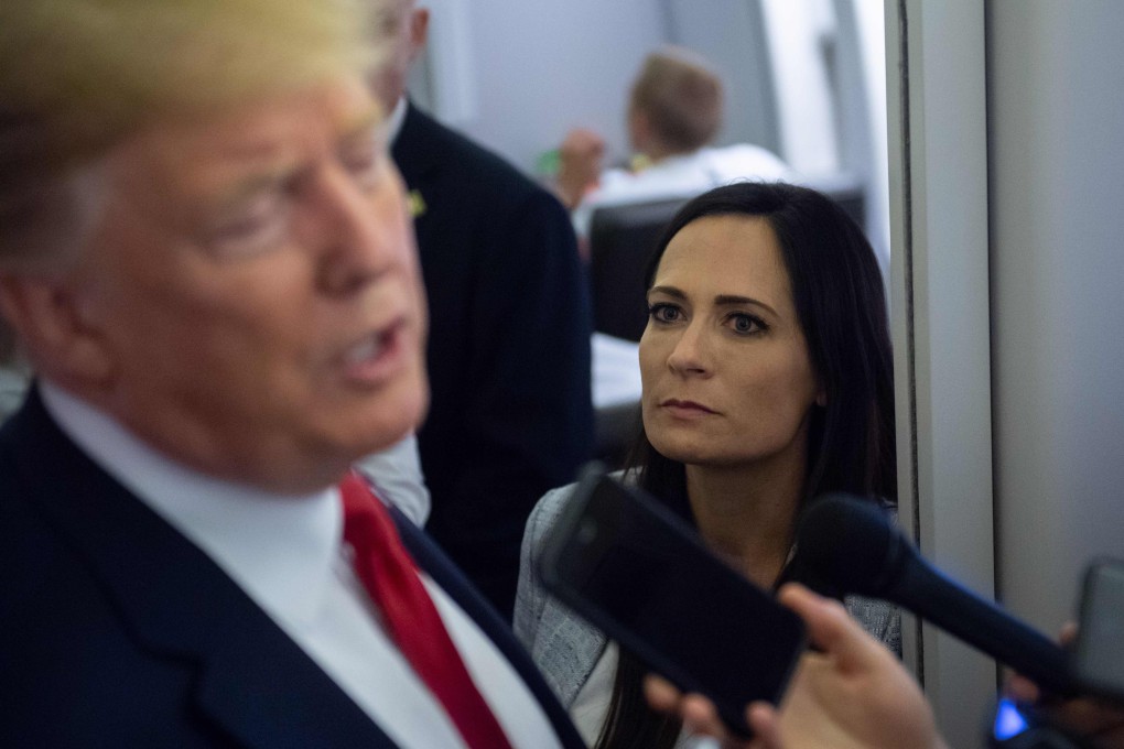 White House Press Secretary Stephanie Grisham listens as US President Donald Trump speaks to the media. Photo: AFP