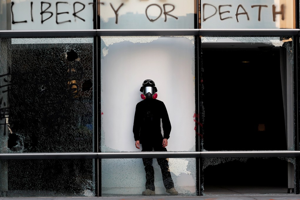 A protester at Polytechnic University in Hong Kong on November 16 under the message: “Liberty or Death”. A third option might be to effect change from within, starting with the district council elections. Photo: Reuters