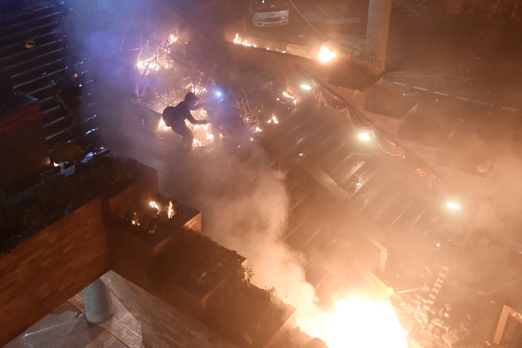 Anti-government protesters start a fire on a flight of steps leading to the Hong Kong Polytechnic University on November 19. Photo: AFP