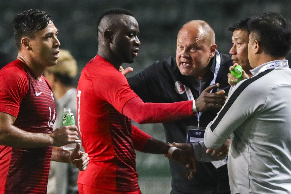 Hong Kong coach Mixu Paatelainen (centre) gives instructions to Alex Akande (second from left) and James Ha (left) in their World Cup qualifier against Cambodia. Photos: May Tse
