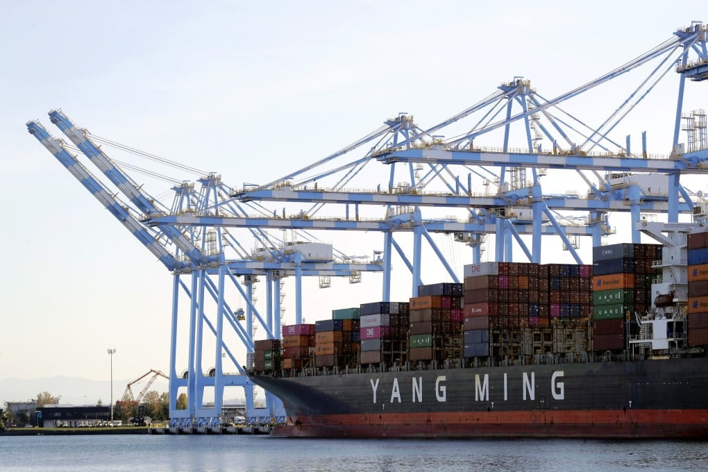 Cargo cranes are used to take containers off of a Yang Ming Marine Transport Corporation boat at the Port of Tacoma. Photo: AP Photo