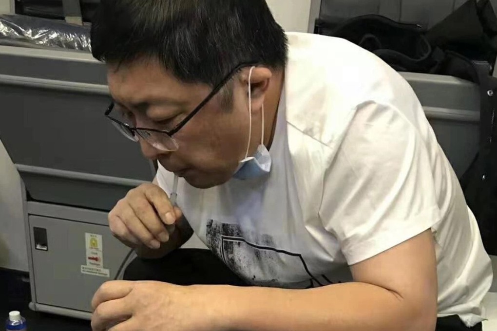 Surgeon Zhang Hong draws out the fluid to ease pressure on the patient’s bladder. Photo: Southern Airlines via WeChat