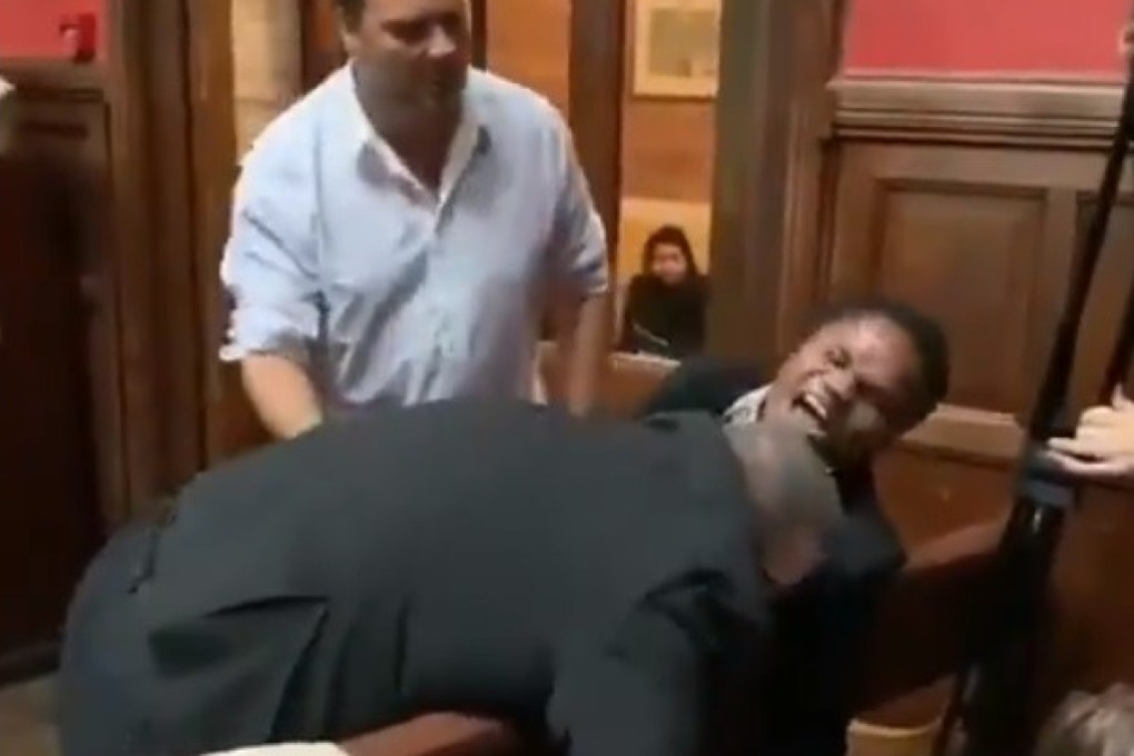 Footage posted online shows two men trying to remove blind Ghanaian student Ebenezer Azamati from the Oxford Union chamber. Photo: Oxford Africa Society via Twitter