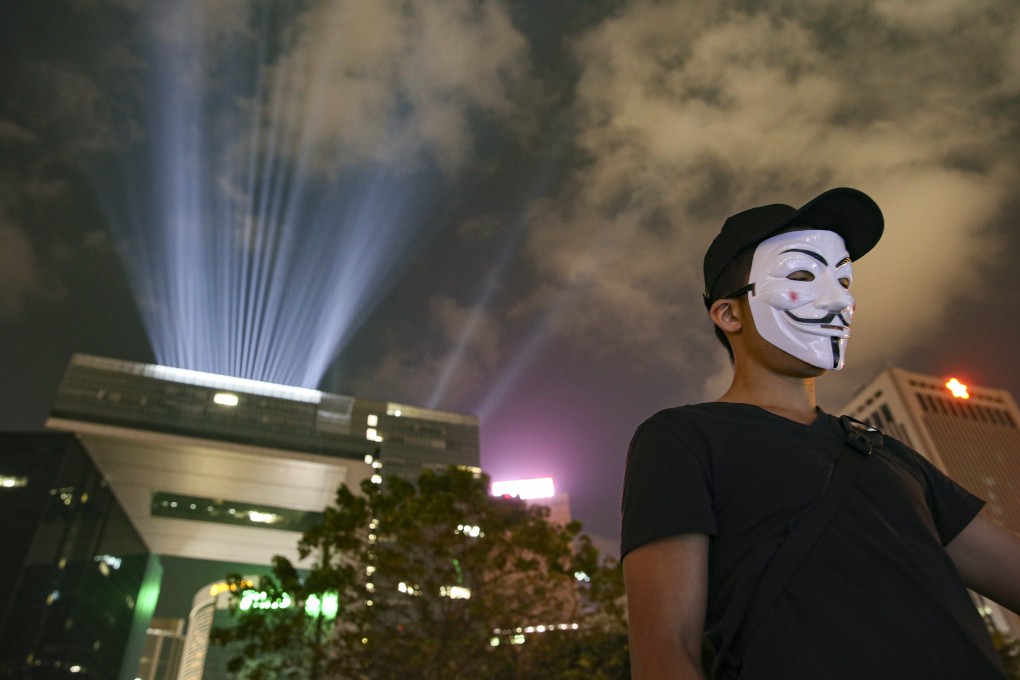 A masked anti-government protesters at Hong Kong’s Tamar Park. Photo: Winson Wong