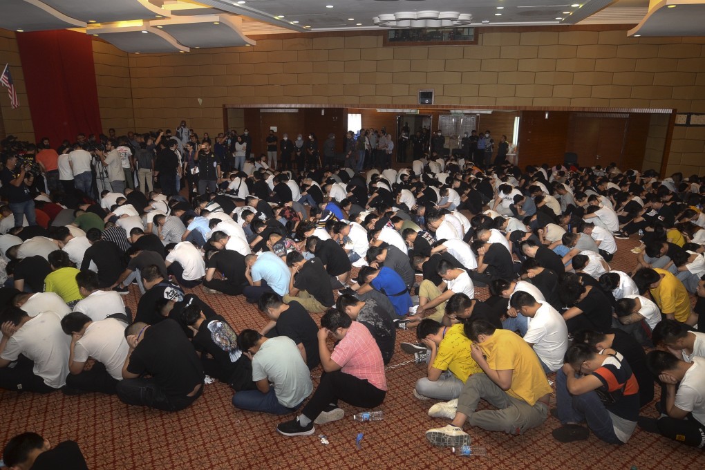 Some of the 680 people – said to be Chinese nationals – arrested by Malaysia’s Immigration Department in the raid on the online scam headquarters. Photo: AP