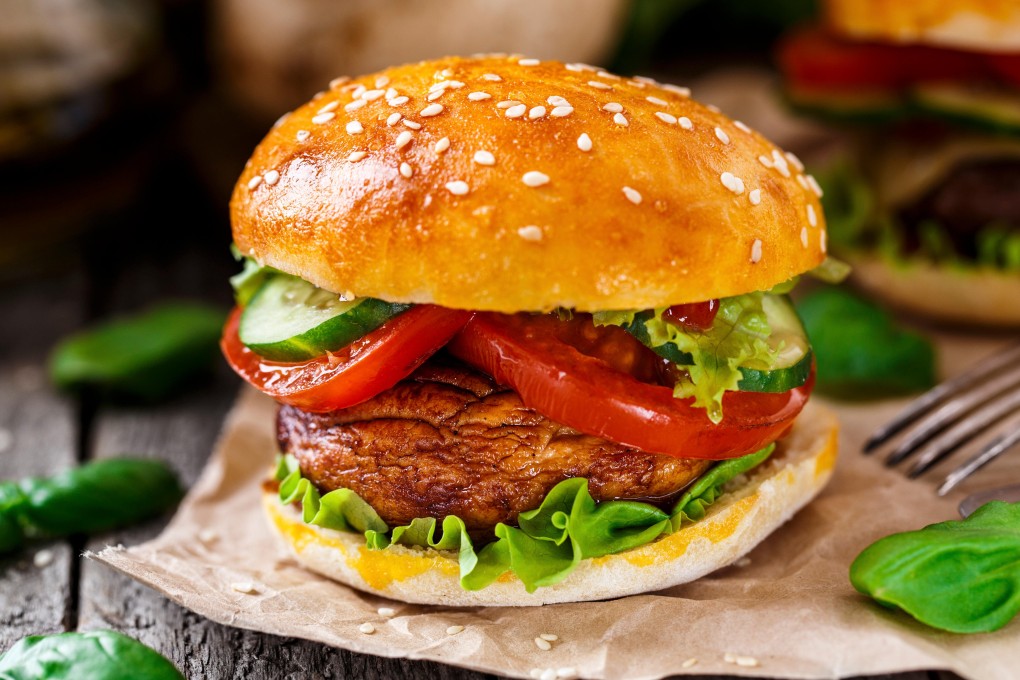 A vegetarian burger with grilled champignon, tomato and cucumber. Photo: Alamy