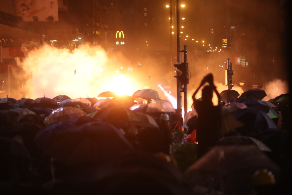 Anti-government protesters clash with riot police on Nathan Road in Yau Ma Tei on Monday. Photo: Winson Wong