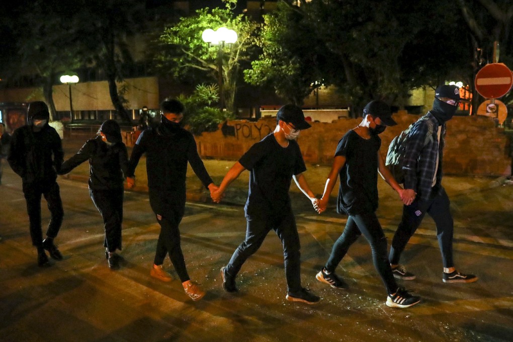 Protesters surrender to police outside the Hong Kong Polytechnic University on Friday. Photo: Sam Tsang