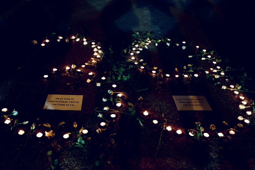 Candles are lit during a prayer for 39 people found dead in the back of a truck near London, in Hanoi. Photo: Reuters