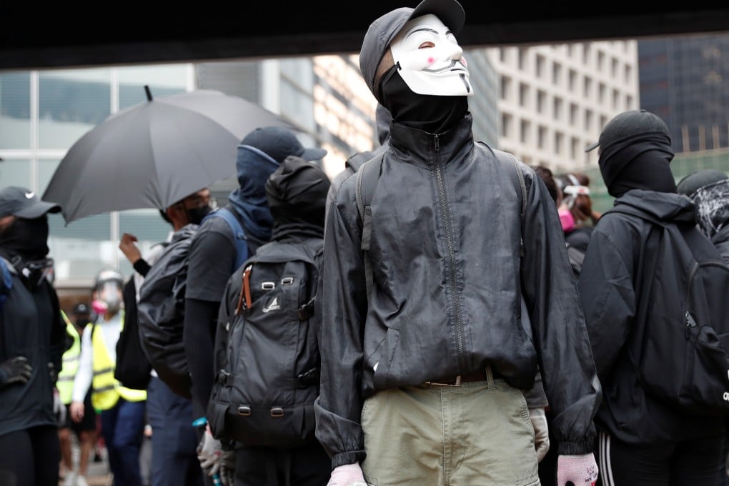 A demonstrator wears a face mask during an anti-government protest in Central, despite a government ban on masks during protests. Photo: Reuters