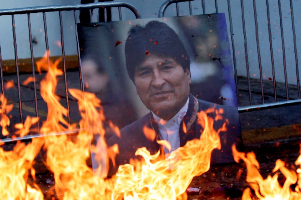 Demonstrators burn a picture of ousted Bolivian president Evo Morales. Photo: EPA-EFE