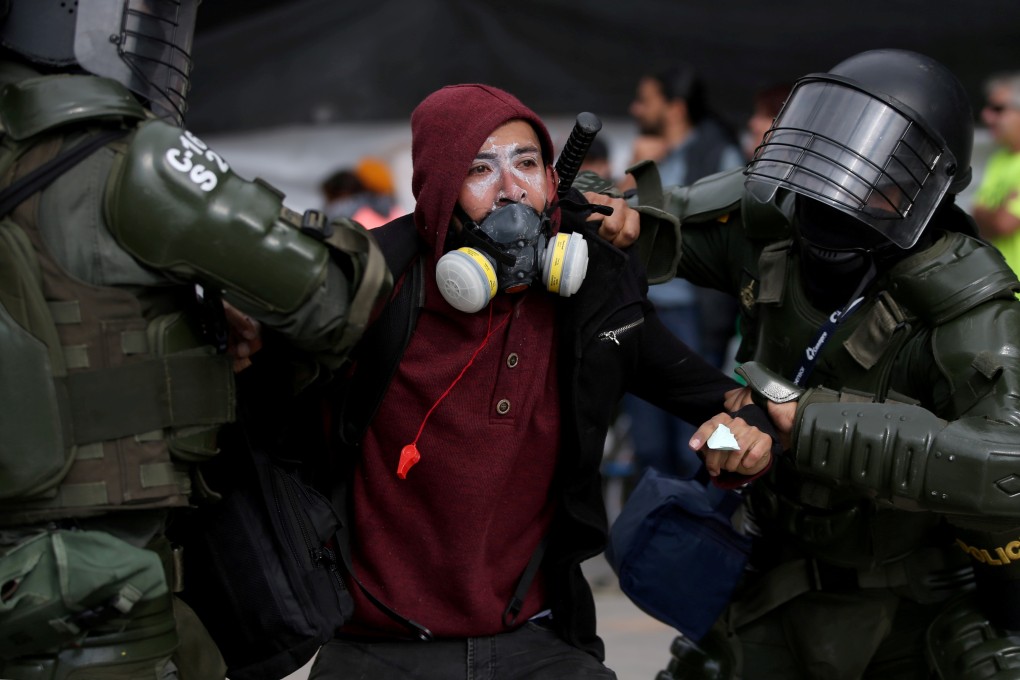 A demonstrator is detained by police officers during a protest in Bogota, Colombia. Photo: Reuters