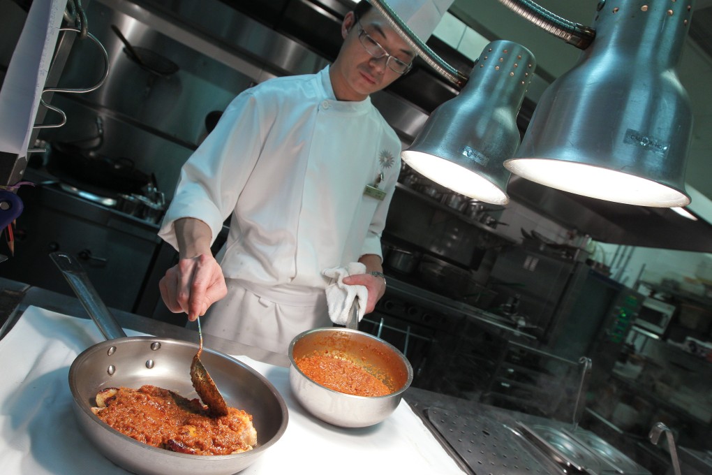 Junior sous chef Chun Leong-sze prepares an African chicken dish – one fusion dish that sheds light on the former colony’s history and culture – at Perola Portuguese restaurant, the Sands Macao in Macau. Photo: Jonathan Wong