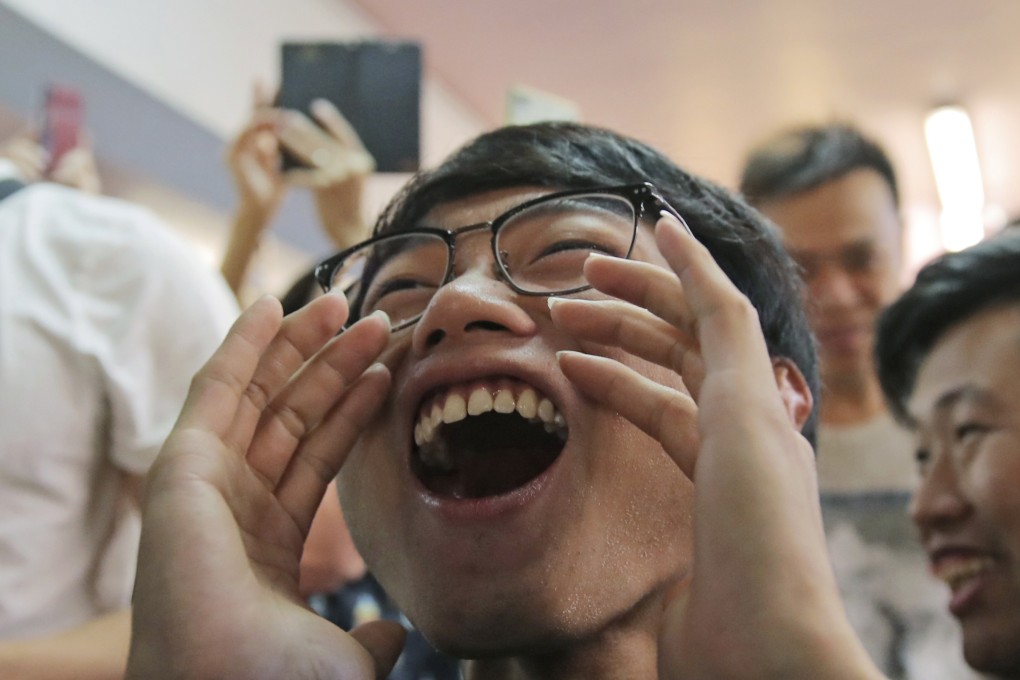 Pro-democracy supporters celebrate after a pro-Beijing politician loses his bid for a district council seat in Hong Kong early Monday. Photo: AP