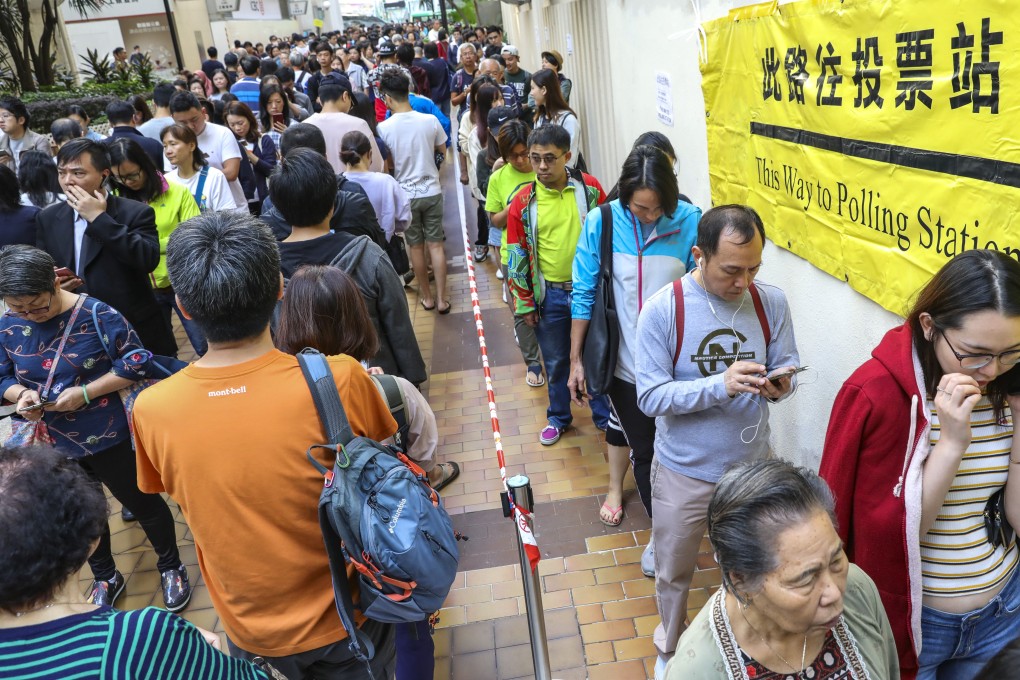People queue up for the district council election at polling stations in Aberdeen Sports Centre. Photo: May Tse