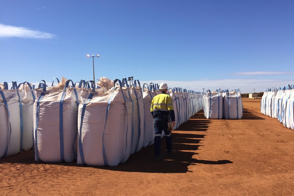 A Lynas Corp worker walks past sacks of rare earth concentrate at Mount Weld, northeast of Perth, Australia. Photo: Reuters