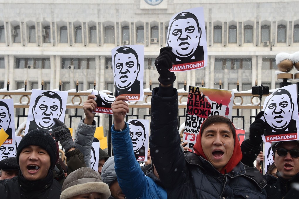 Demonstrators shout slogans and hold placards during an anti-corruption rally in Bishkek. Photo: AFP
