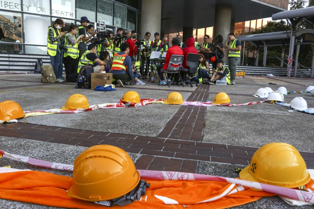 Two men inside Polytechnic University slam police for depriving them of their right to vote. Photo: Jonathan Wong