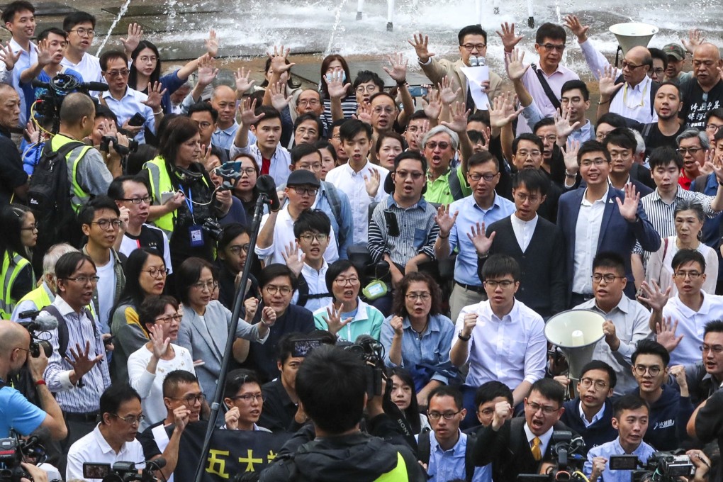 Members of the Democratic Party celebrate in Tsim Sha Tsui after a landslide win in the district council elections. Photo: Felix Wong