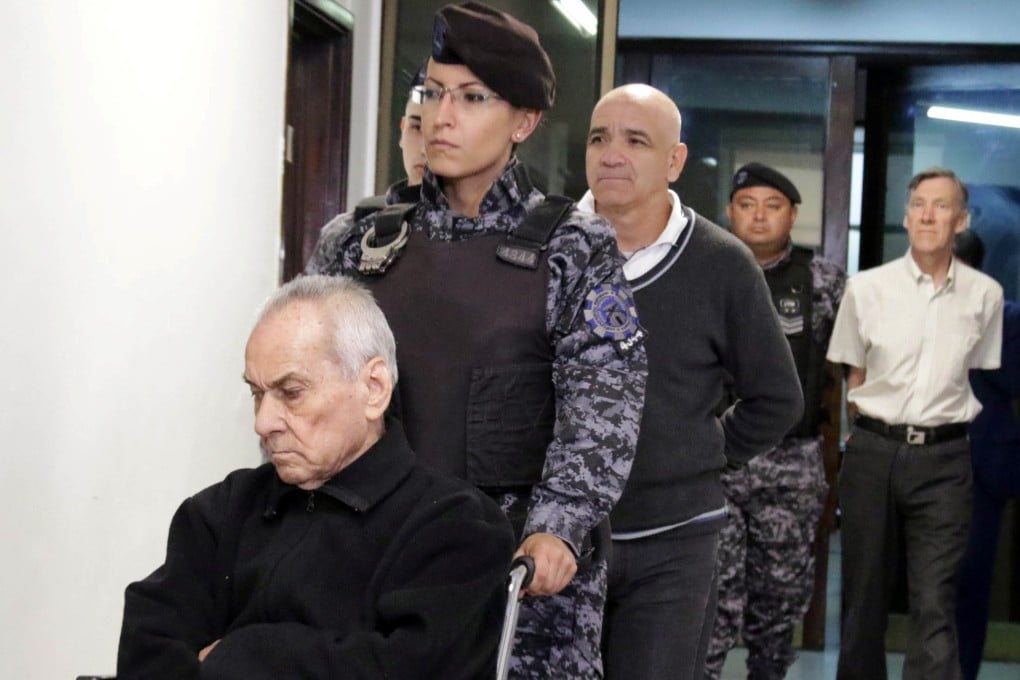 Nicola Corradi, Armando Gomez and Horacio Corbacho are escorted by officers to a courtroom before the hearing of their verdict in Mendoza, Argentina on Monday. Photo: Reuters