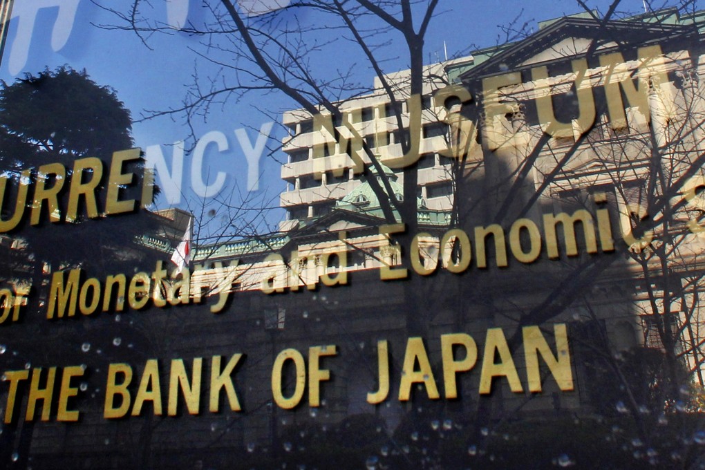 The Bank of Japan, reflected in the glass wall of its adjunct museum in Tokyo. Historically low to negative interest rates have forced Japanese investors to seek returns outside Japan. Photo: AP