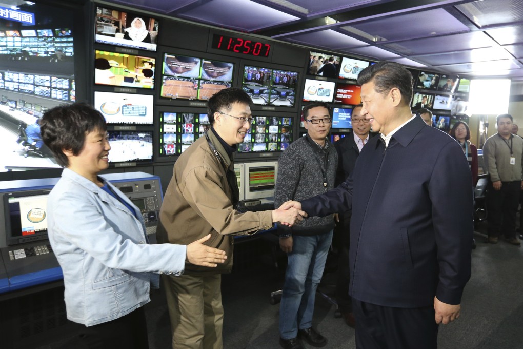 Chinese President Xi Jinping shakes hands with workers at China Central Television. Photo: AP