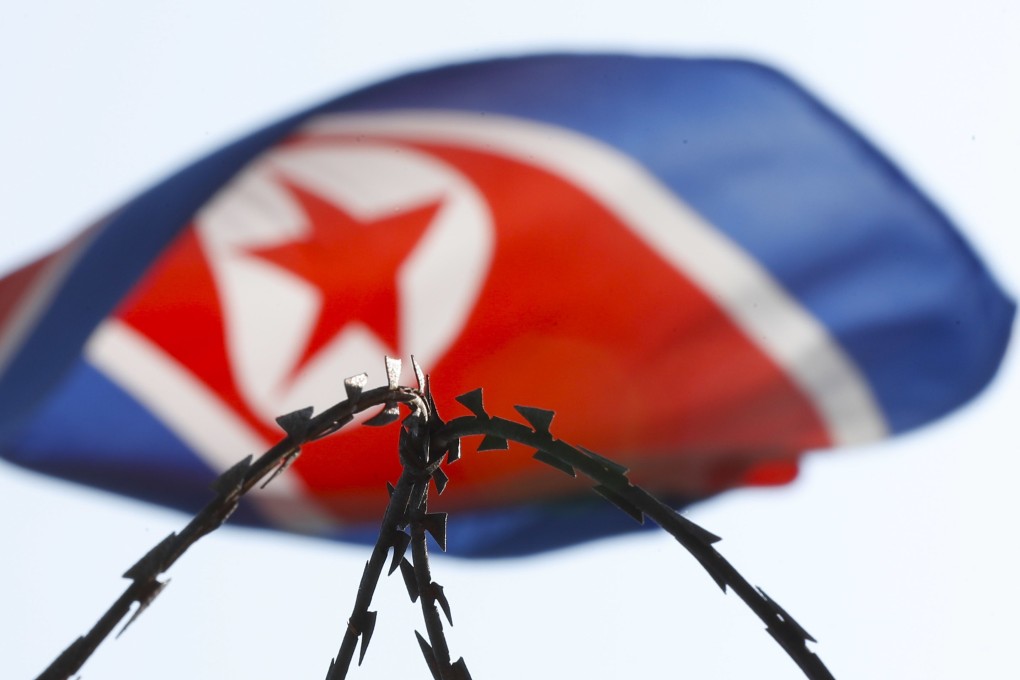 The North Korean flag is seen behind razor wire on top of a wall at Pyongyang’s closed embassy in Kuala Lumpur. Photo: AP
