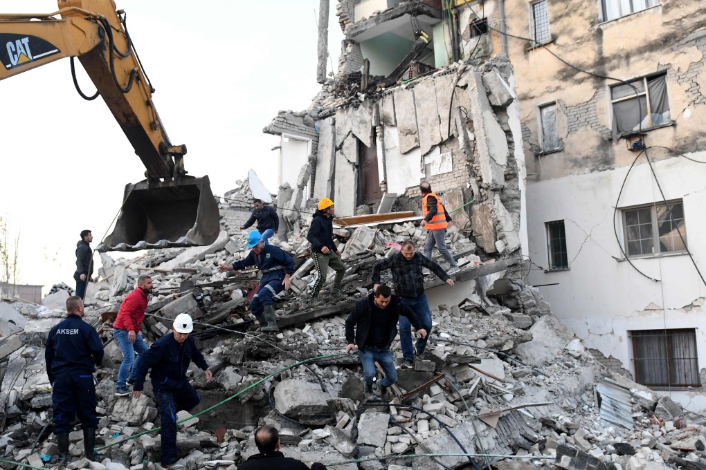 Emergency workers clear debris at a damaged building in Thumane, 34km northwest of the capital Tirana, after an earthquake hit Albania. Photo: AFP