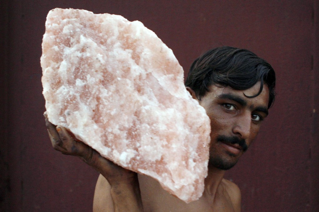 A labourer carries rock salt at Khewra, Pakistan. Pink salt has become a political issue in Pakistan, after a story on social media that India has been re-exporting the salt worldwide and labelling it “made in India”. Photo: Reuters