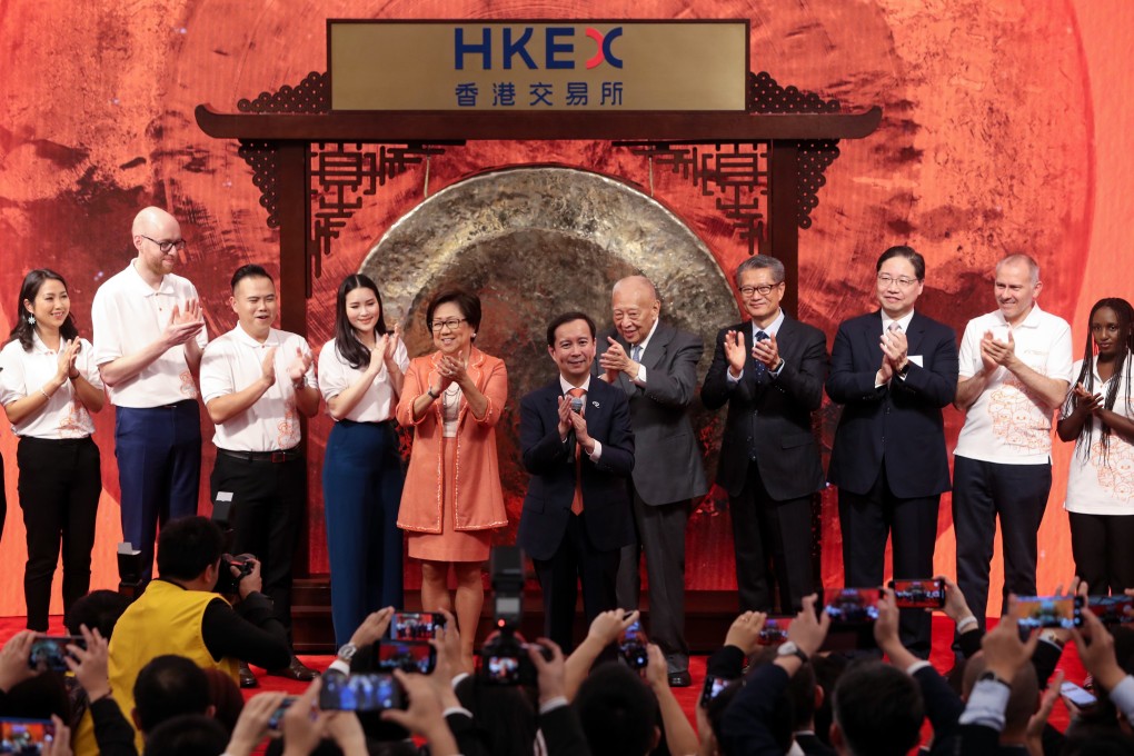 Daniel Zhang Yong, Chief Executive Officer of Alibaba Group attends the company's stock trading debut at the Hong Kong Exchanges and Clearing on November 26, 2019. He is flanked by board member Tung Chee-hwa and Laura Cha Shih May-lung, chairwoman of HKEX. Photo: Sam Tsang
