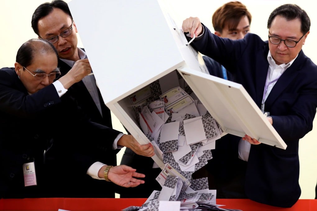 Officials open a ballot box at a polling station in Kowloon Tong in Hong Kong on Sunday. Photo: Reuters
