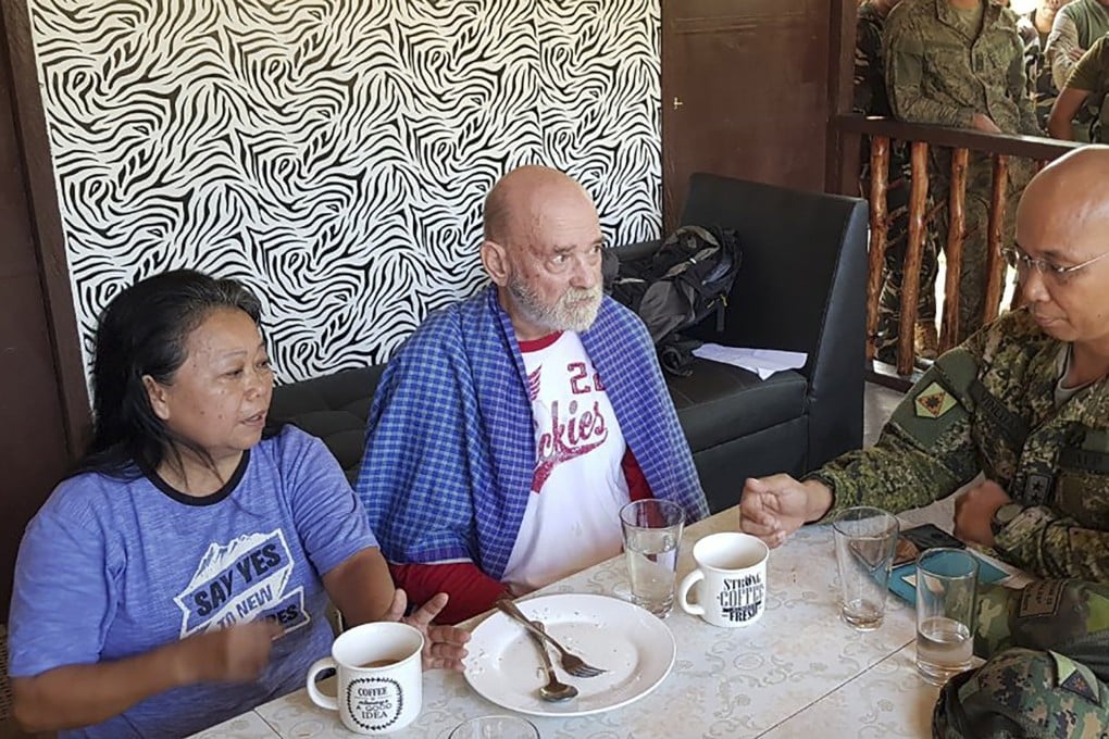 Allan Hyrons, centre, and his wife Wilma, left, speak with Philippine Major General Corleto Vinluan. Photo: AP