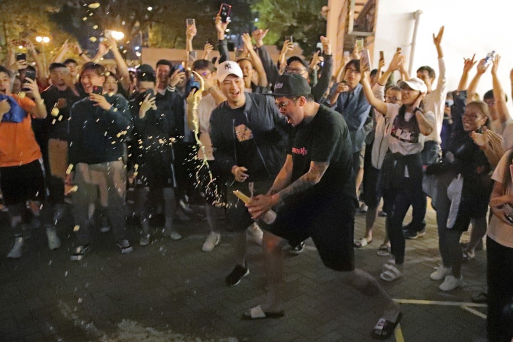 Pro-democracy supporters celebrate in the early hours of November 25 after pro-Beijing politician Junius Ho Kwan-yiu lost his seat in the district council elections. Photo: AP