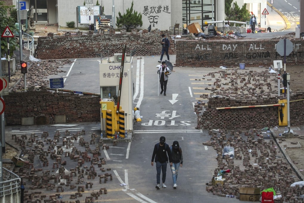 Anti-government protesters set up roadblocks outside Chinese University in Sha Tin in preparation for clashes with riot police. Photo: Sam Tsan