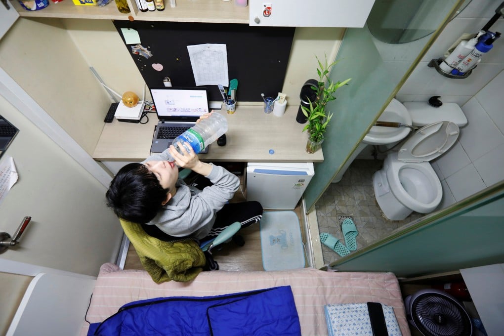 Self-professed ‘dirt spoon’ Kim Jae-hoon drinks water in his tiny cubicle home in Seoul. Photo: Reuters