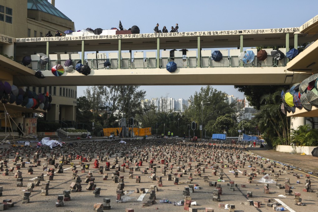 Anti-government protesters set up roadblocks and other defences outside Baptist University in Kowloon Tong earlier this month. Photo: Xiaomei Chen