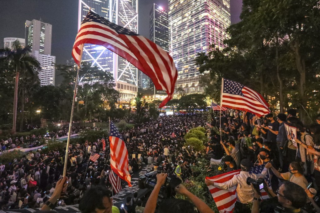 Anti-government protesters wave US flags during a demonstration in Central in October to urge the US Congress to pass the Hong Kong Human Rights and Democracy Act. Photo: Felix Wong