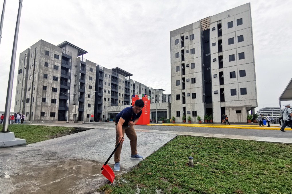 A man works in front of the athletes’ village inside the New Clark City Sports Complex for the SEA Games in the Philippines. Photo: EPA