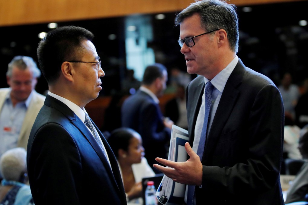 Chinese Ambassador to the WTO Zhang Xiangchen (left) chats with his US counterpart Dennis Shea before a WTO meeting in Geneva in July last year. Photo: Reuters