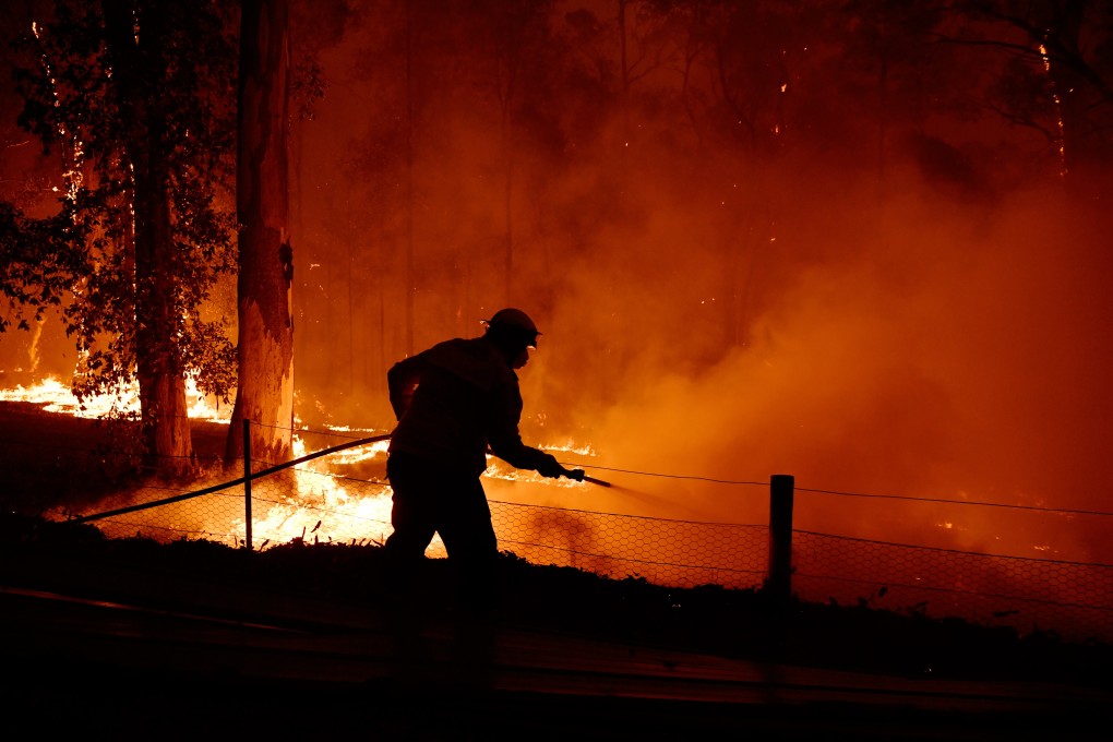 A firefighter works to battle a blaze on the outskirts of Sydney earlier this month. Photo: DPA