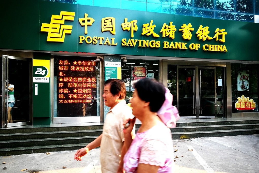 Pedestrians walk past a branch of Postal Saving Bank of China in Huaibei city, in China’s Anhui province. Photo: Imaginechina