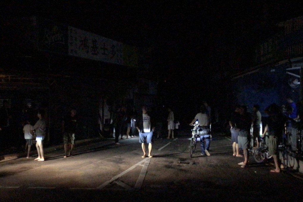 Residents in the dark amid the blackout in Shek O. Photo: Amanda Johnstone