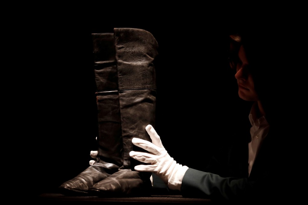 Boots that might have been worn by French emperor Napoleon during his final exile in Saint Helena are handled before being put on auction at Drouot auction house in Paris on Thursday. Photo: Reuters