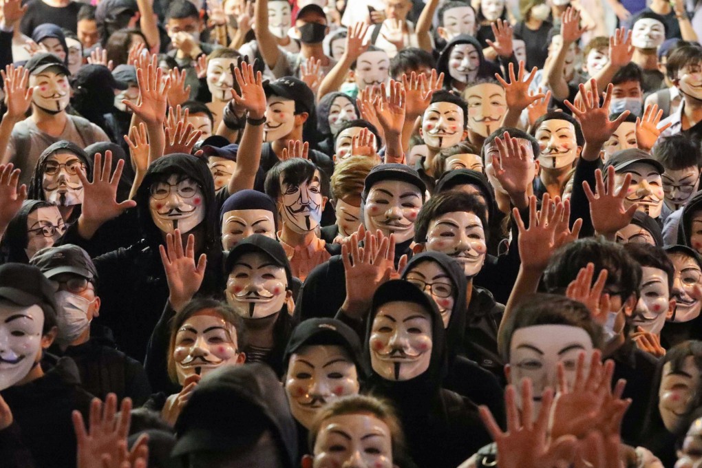 Anti-government protesters with Guy Fawkes masks in Tsim Sha Tsui. Photo: Felix Wong